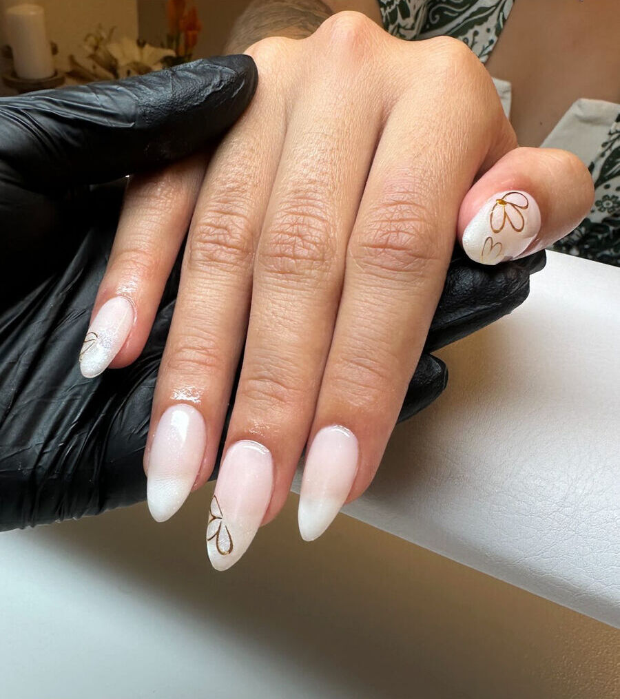 Russian Manicure mit BIAB: helle Nägel mit goldenen Blüten-Akzenten